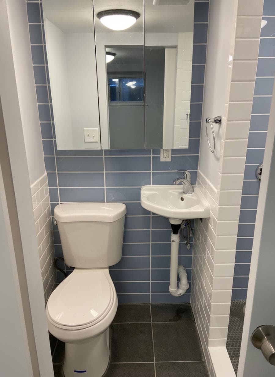 Renovated bathroom with tiled shower and new vanity in a Bridgewater, MA home