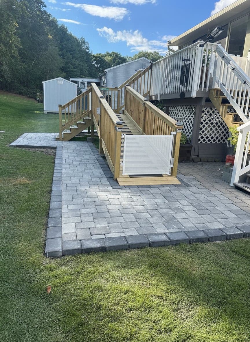 Paver patio with a new deck and accessibility ramp in Bridgewater, MA